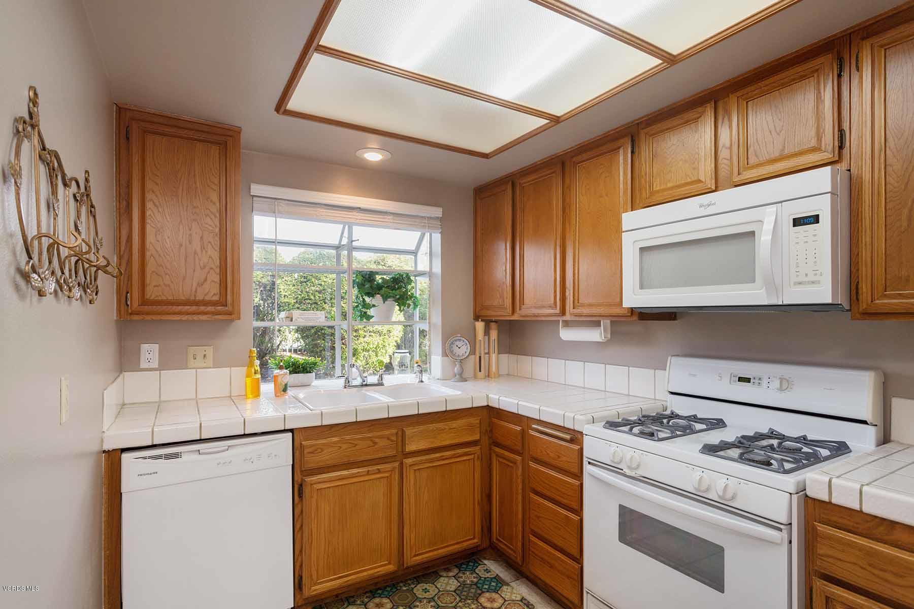 3902 Cochran Street, Unit 4 Simi Valley, CA 93063 - Photo 11 of 26 a kitchen with stainless steel appliances granite countertop a stove a sink and a microwave