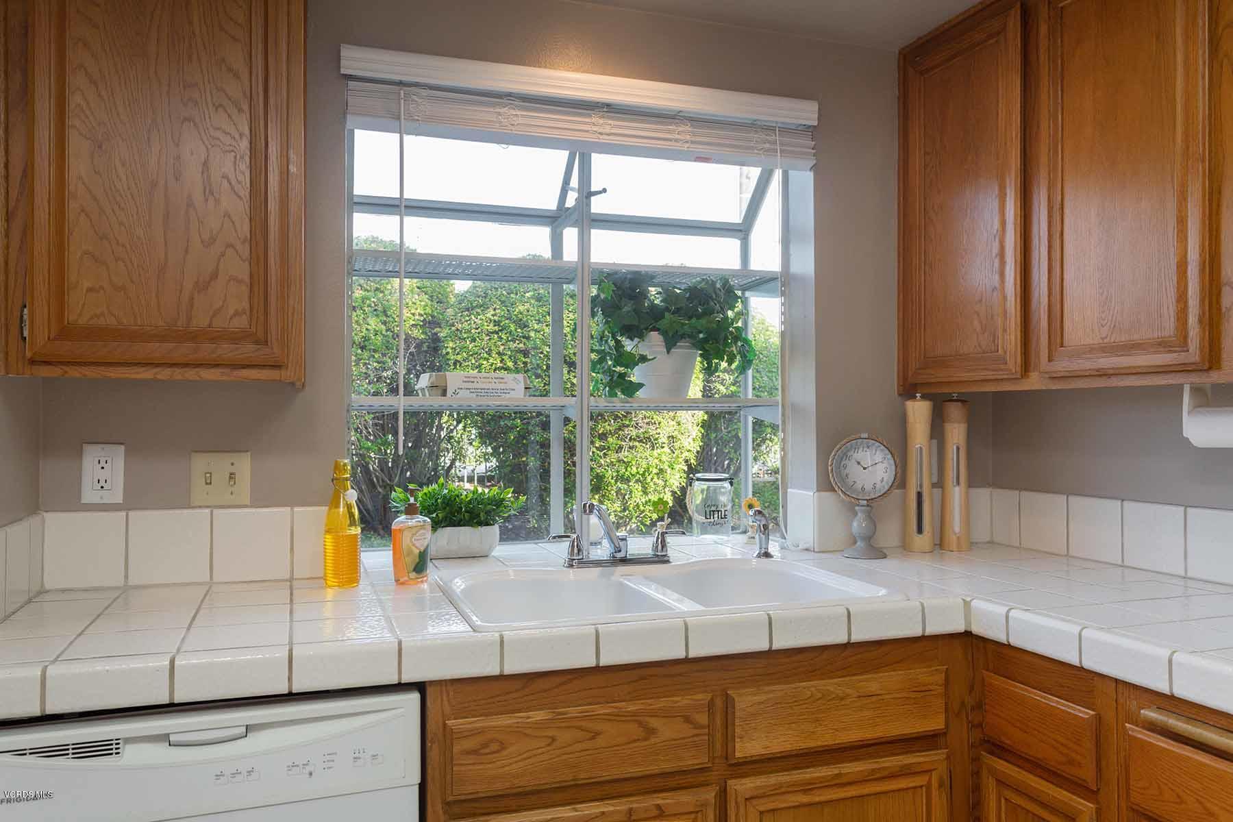 3902 Cochran Street, Unit 4 Simi Valley, CA 93063 - Photo 12 of 26 a kitchen with granite countertop sink and granite counter tops