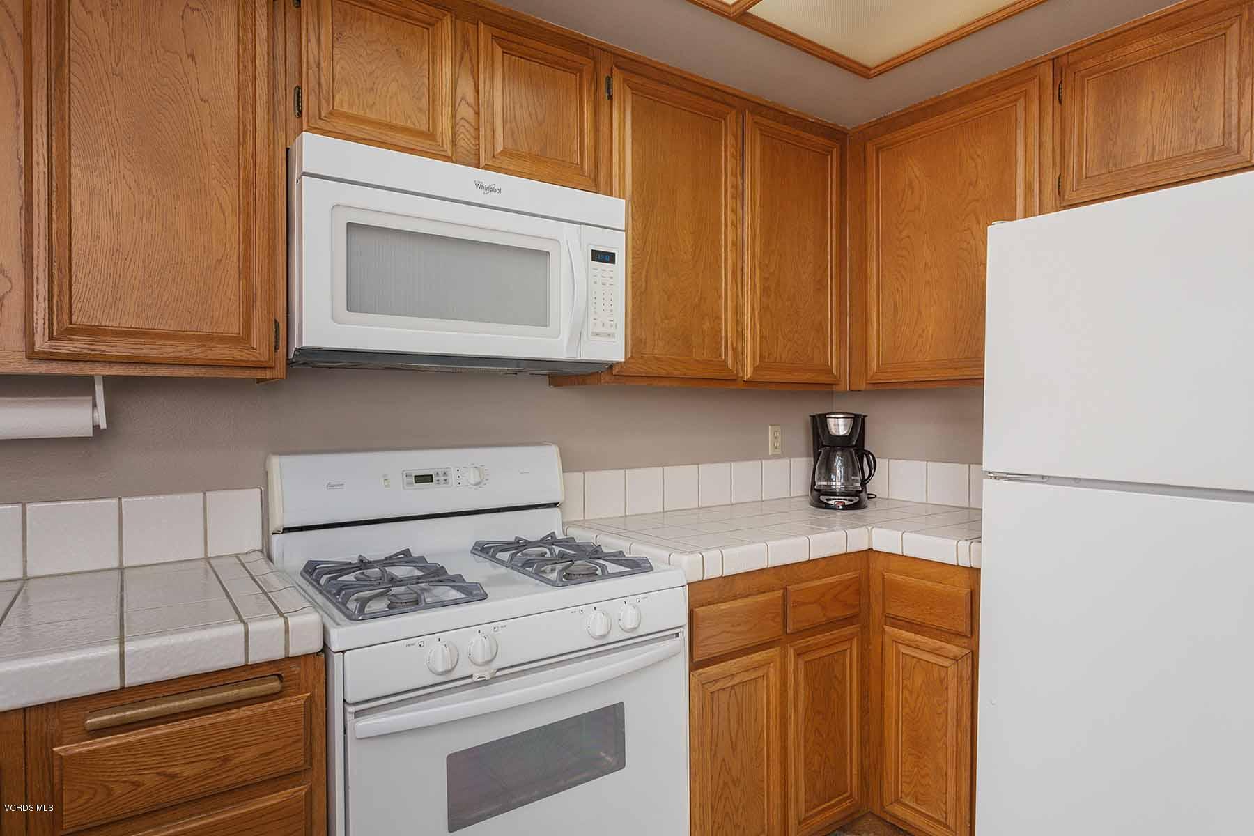 3902 Cochran Street, Unit 4 Simi Valley, CA 93063 - Photo 13 of 26 a kitchen with a stove cabinets and refrigerator