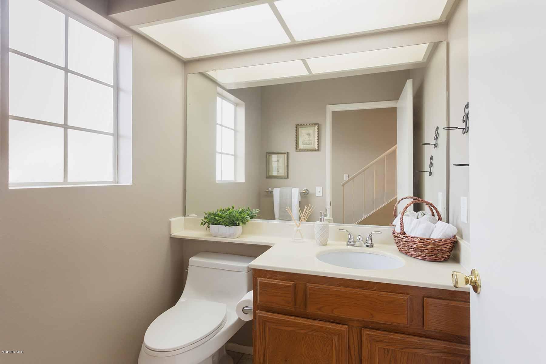 3902 Cochran Street, Unit 4 Simi Valley, CA 93063 - Photo 15 of 26 a bathroom with a sink toilet vanity and mirror