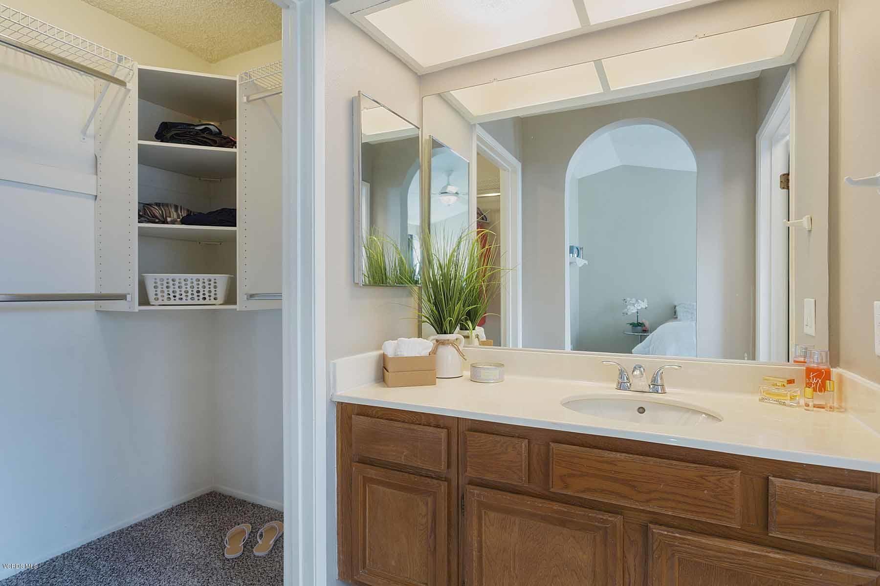 3902 Cochran Street, Unit 4 Simi Valley, CA 93063 - Photo 18 of 26 a bathroom with a double vanity sink and a mirror