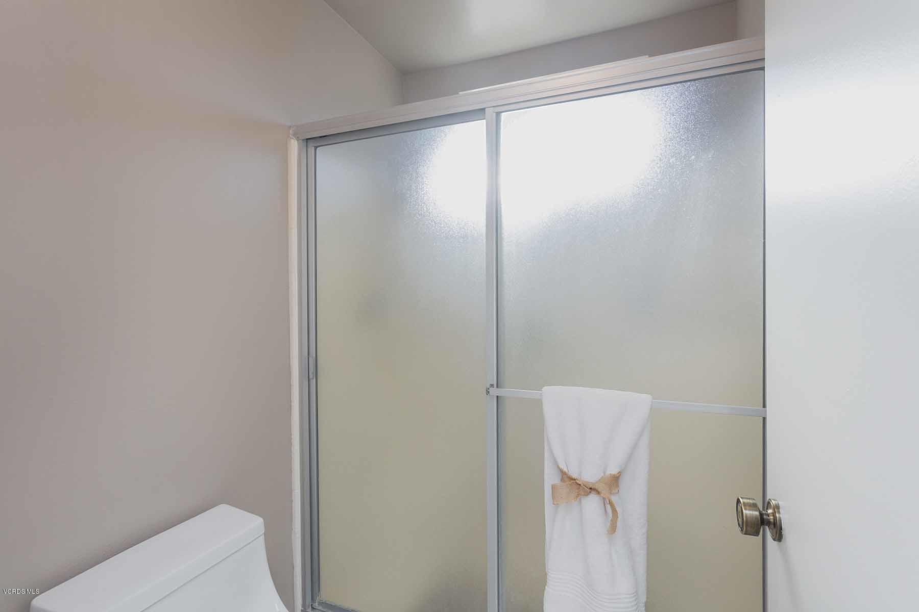 3902 Cochran Street, Unit 4 Simi Valley, CA 93063 - Photo 19 of 26 a bathroom with a glass shower door