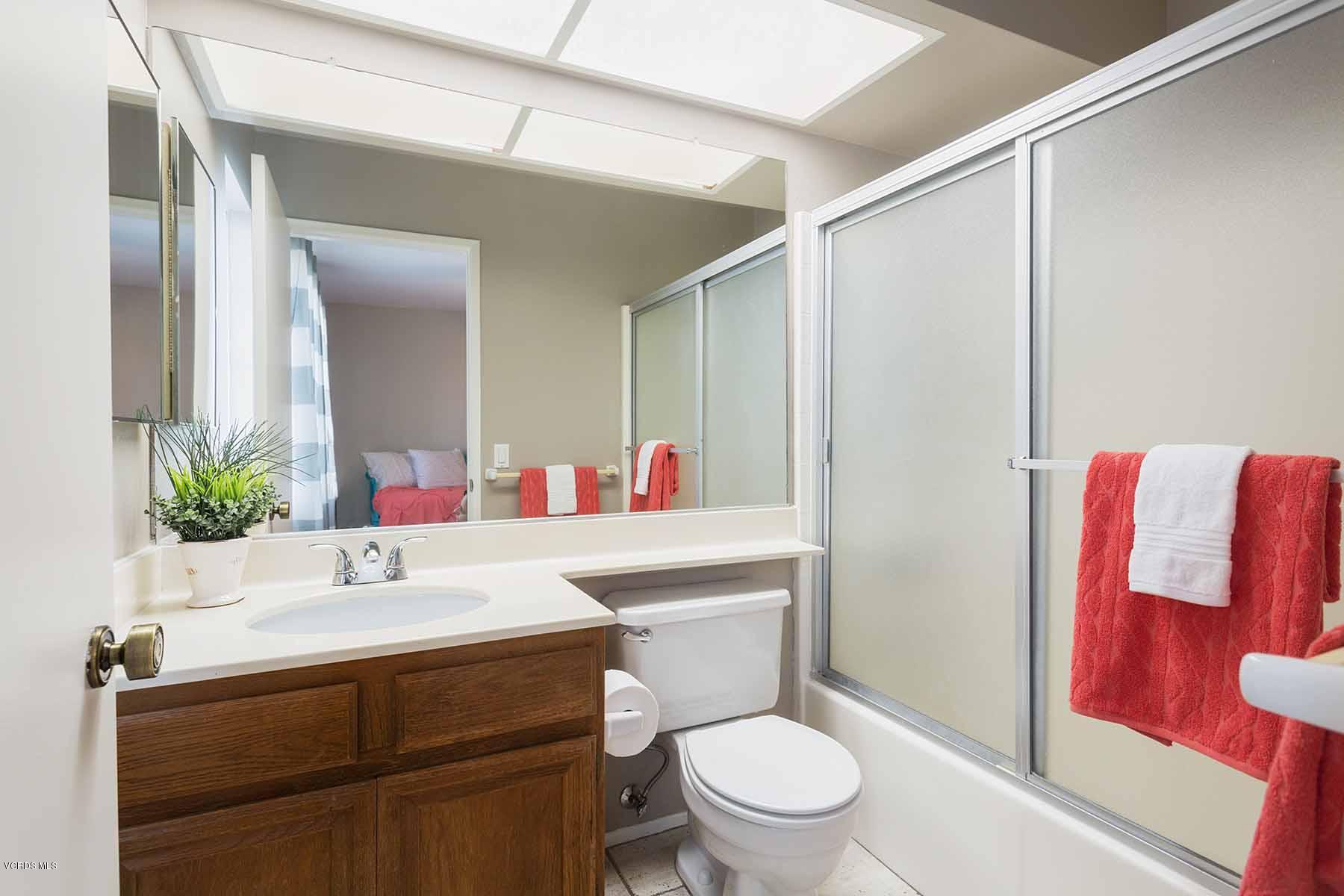 3902 Cochran Street, Unit 4 Simi Valley, CA 93063 - Photo 21 of 26 a bathroom with a sink toilet vanity and shower