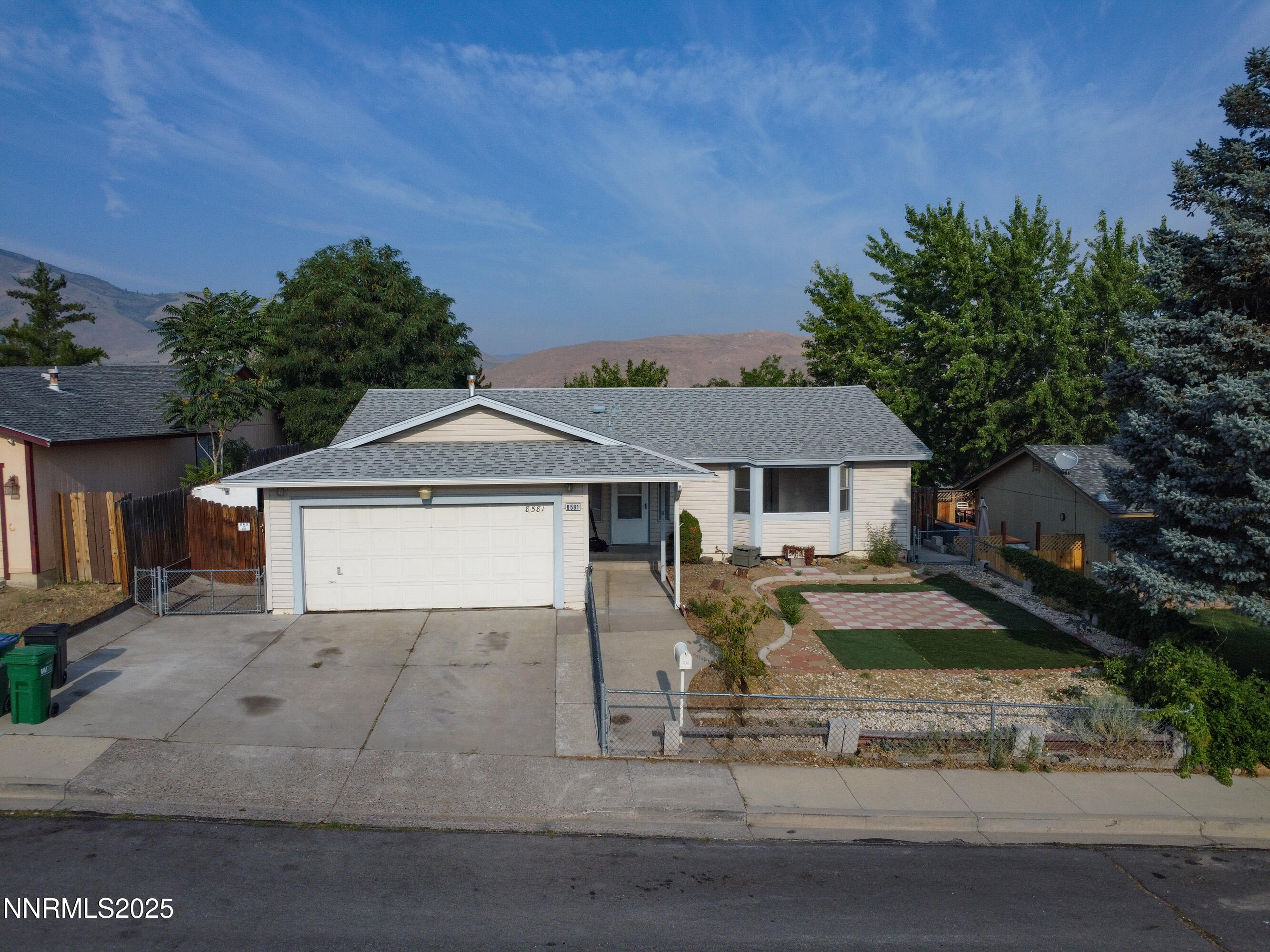8581 Corrigan Way Reno, NV 89506 - Photo 1 of 40 front view of a house with a yard