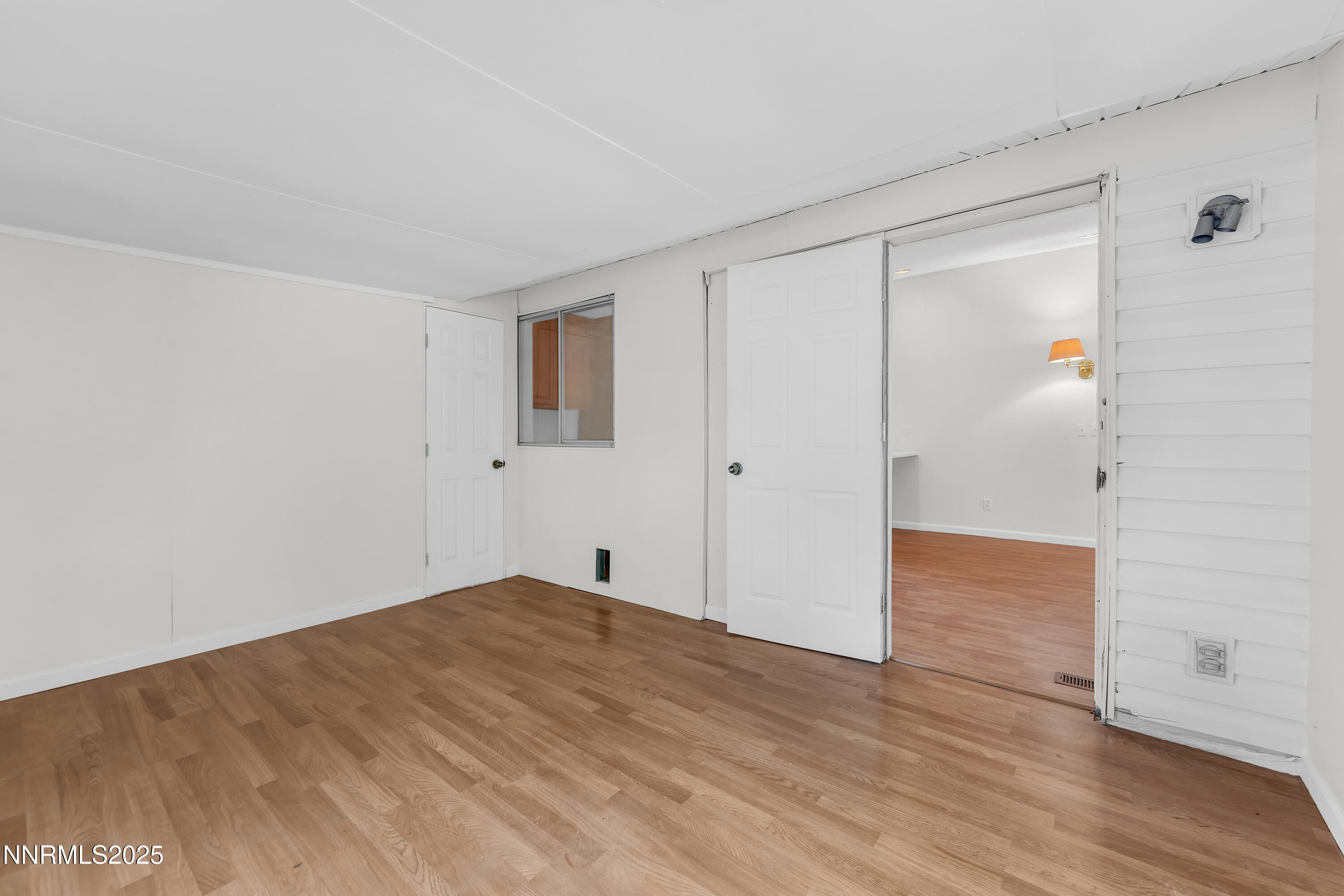 8581 Corrigan Way Reno, NV 89506 - Photo 18 of 40 a view of empty room with wooden floor