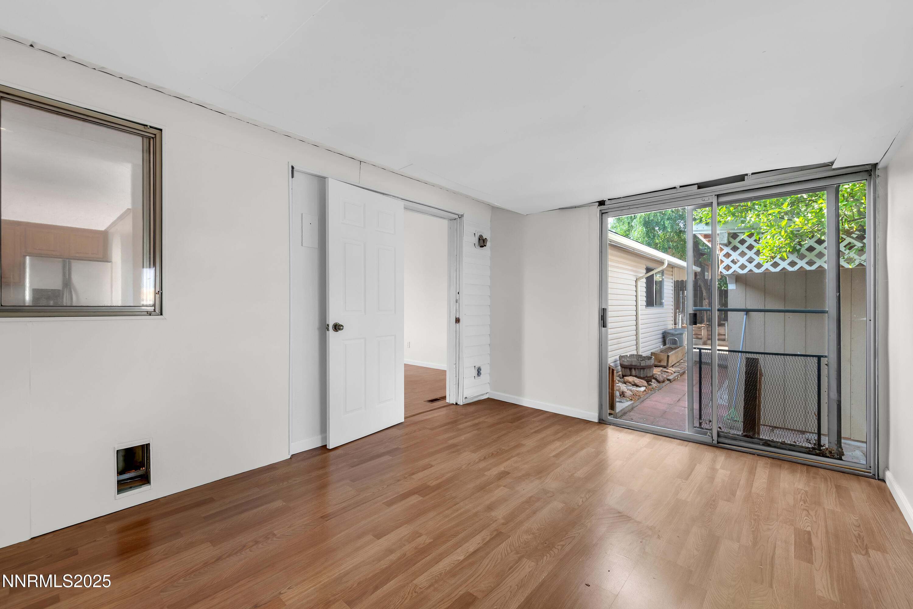8581 Corrigan Way Reno, NV 89506 - Photo 19 of 40 a view of empty room with wooden floor and fan