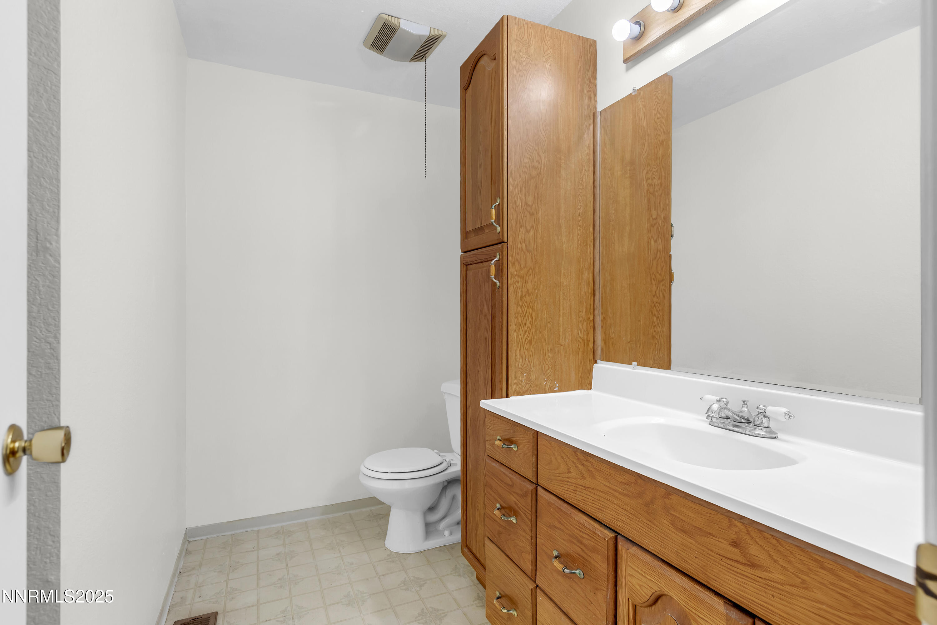 8581 Corrigan Way Reno, NV 89506 - Photo 25 of 40 a bathroom with a granite countertop sink toilet and shower