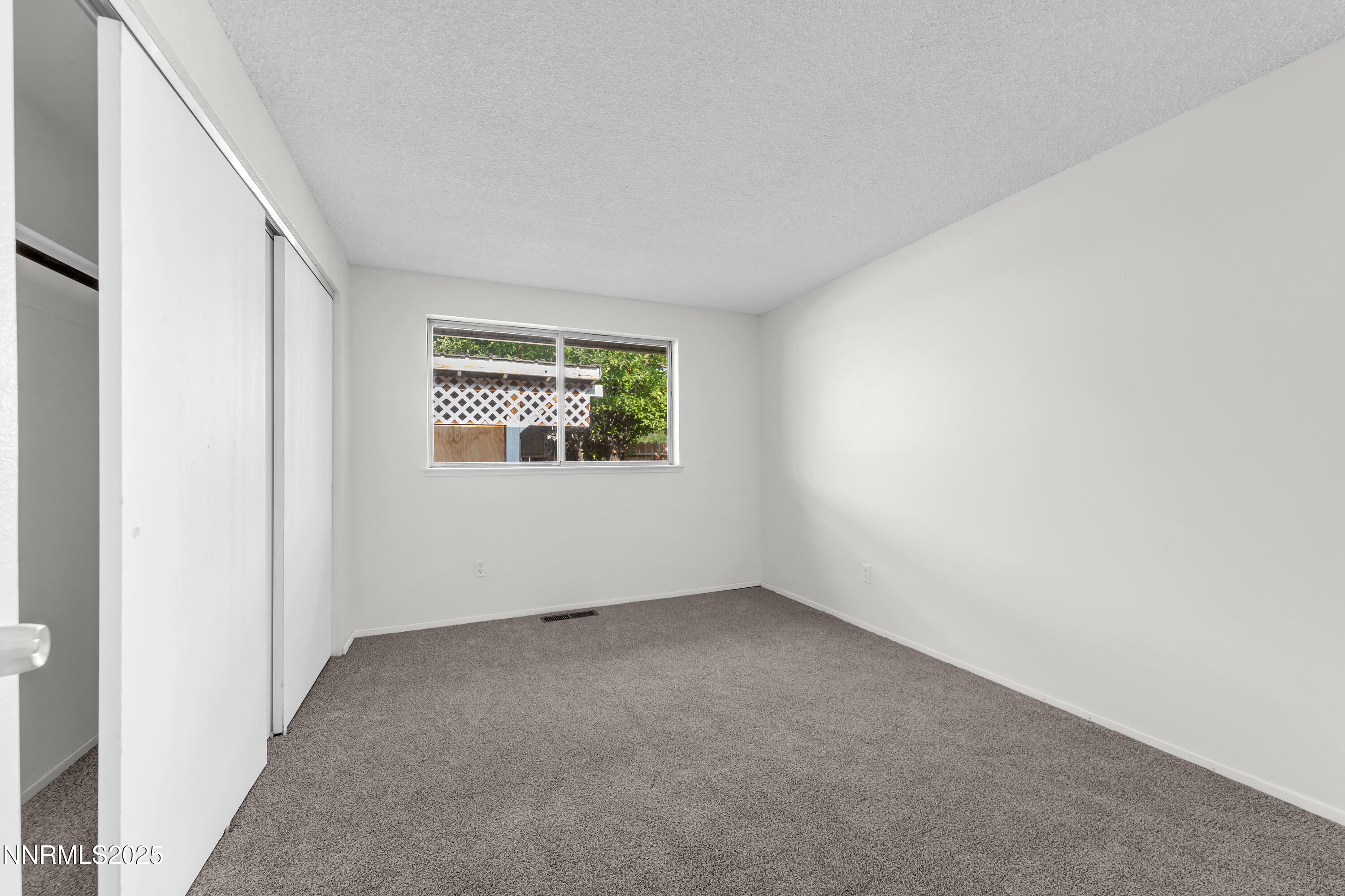 8581 Corrigan Way Reno, NV 89506 - Photo 28 of 40 an empty room with windows