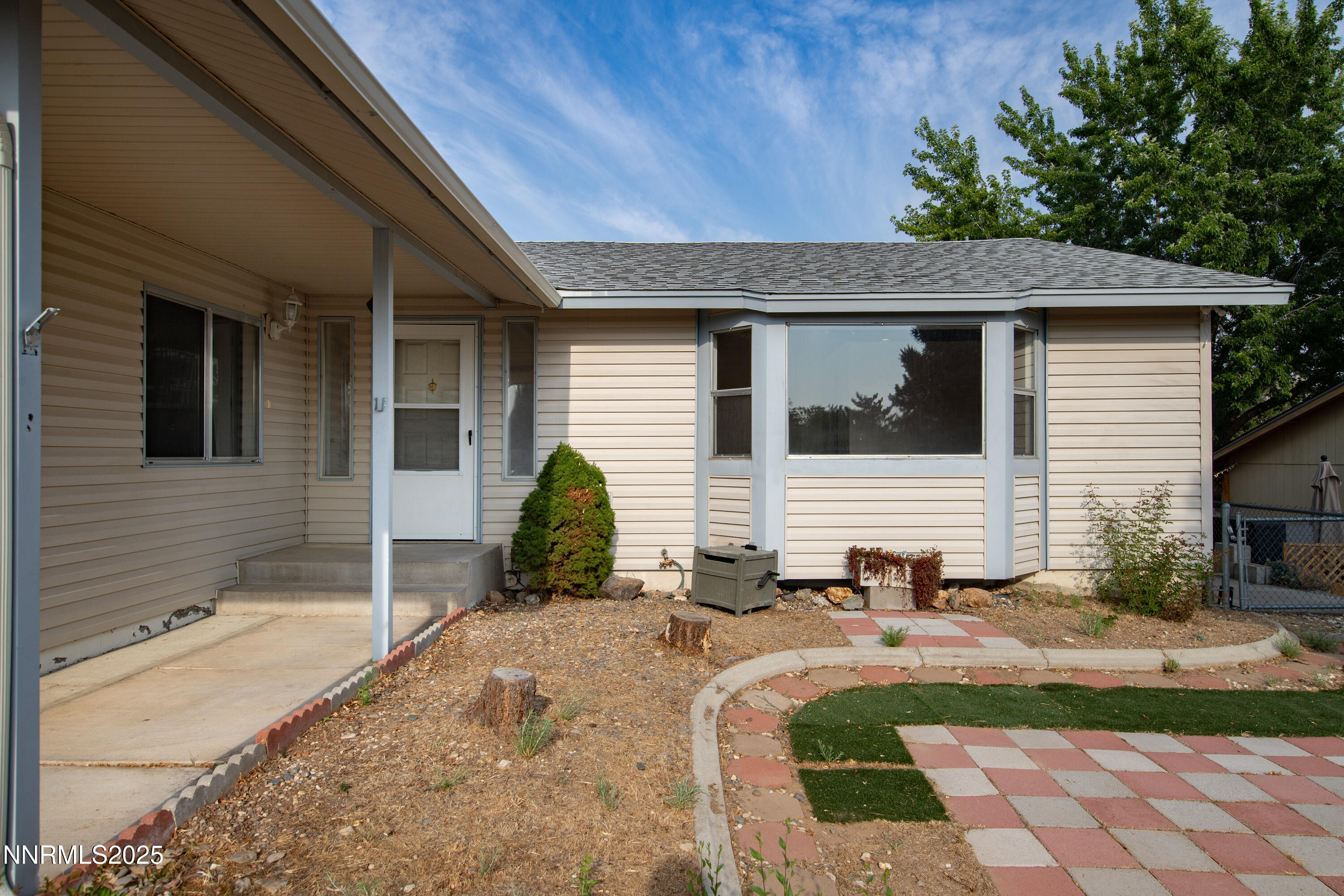 8581 Corrigan Way Reno, NV 89506 - Photo 34 of 40 a front view of a house with a yard