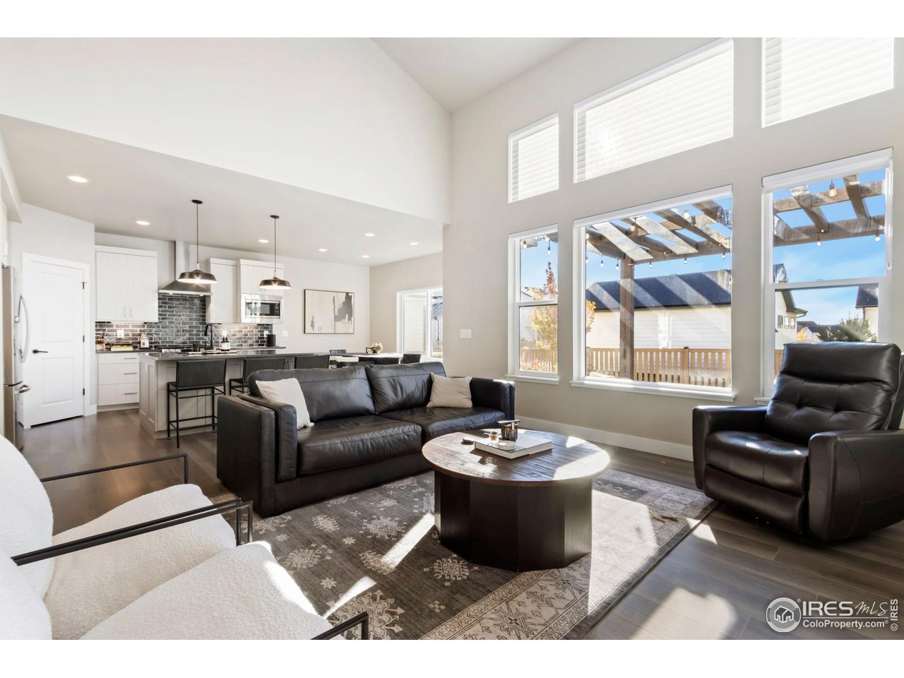 6709 Stone Point Drive Timnath, CO 80547 - Photo 14 of 41 a living room with furniture and a large window