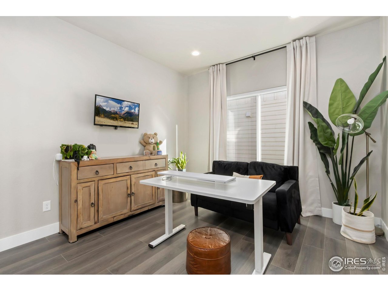 6709 Stone Point Drive Timnath, CO 80547 - Photo 18 of 41 a view of a workspace with furniture and a potted plant