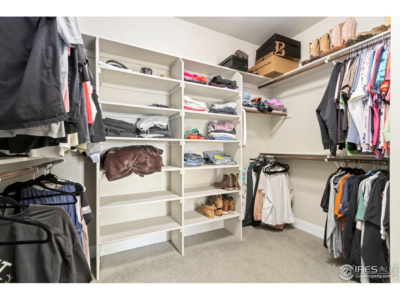 6709 Stone Point Drive Timnath, CO 80547 - Photo 27 of 41 a view of walk in closet with clothes and shoes