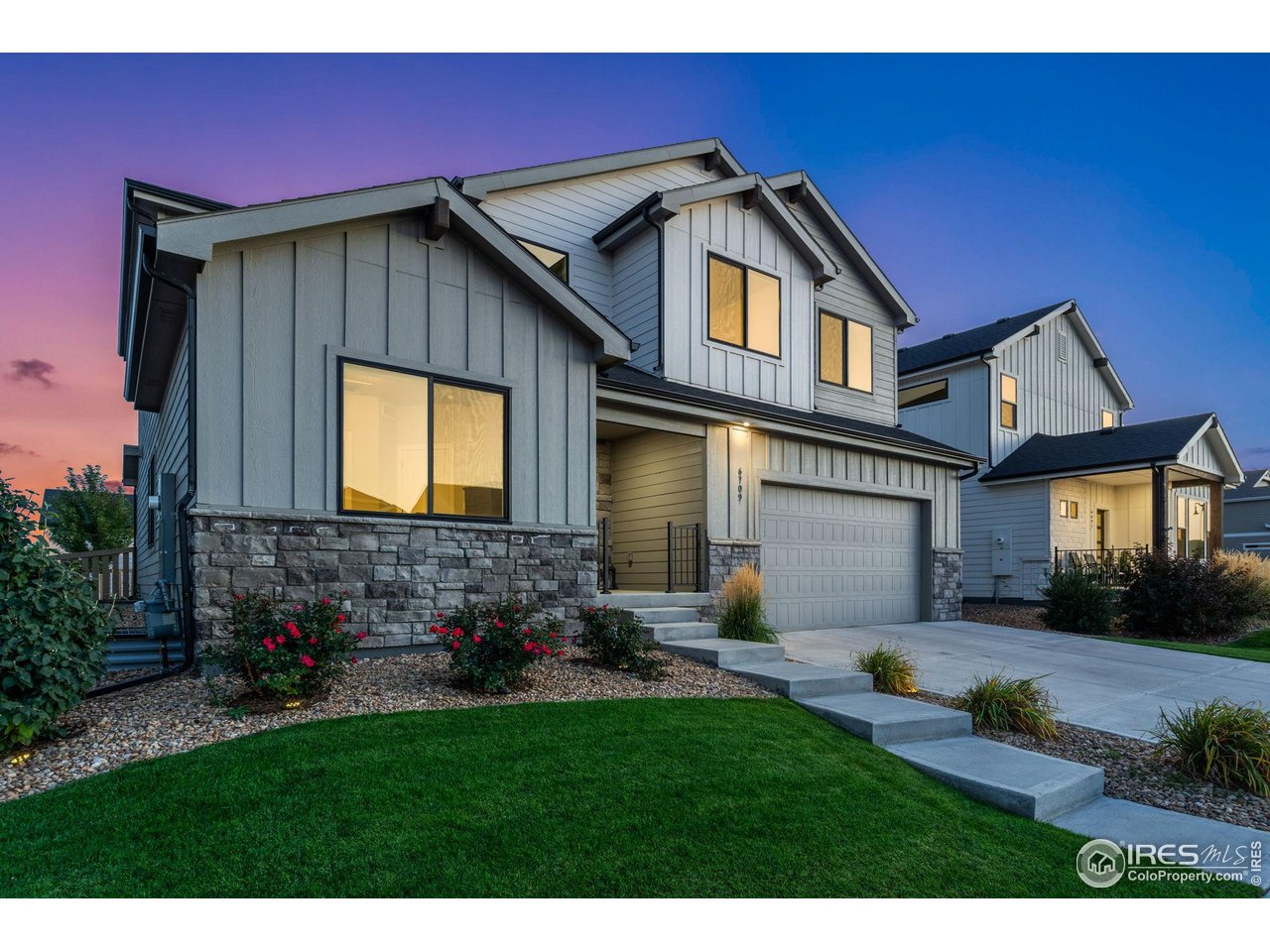 6709 Stone Point Drive Timnath, CO 80547 - Photo 3 of 41 a front view of a house with a yard