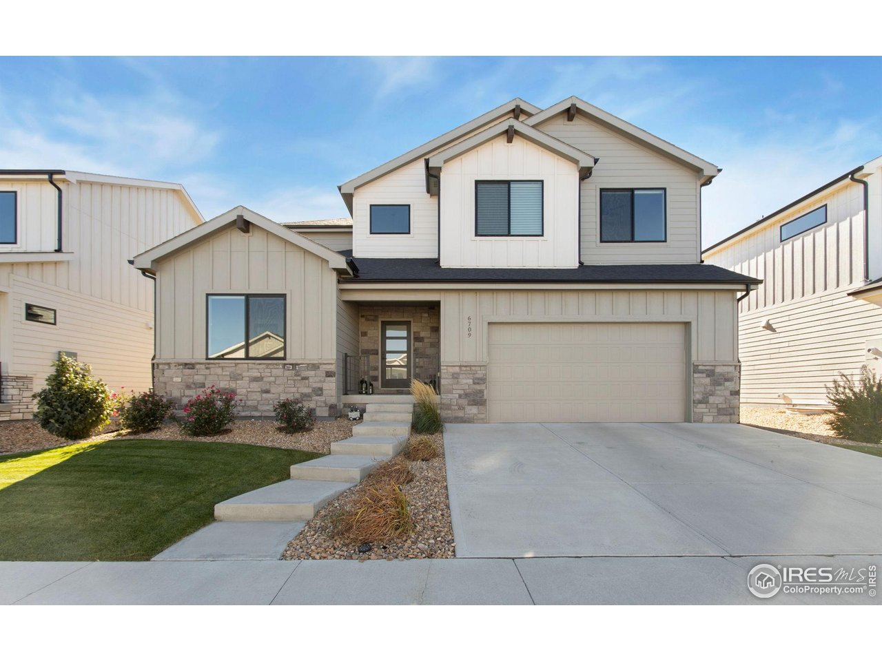 6709 Stone Point Drive Timnath, CO 80547 - Photo 39 of 41 a front view of a house with a yard and garage