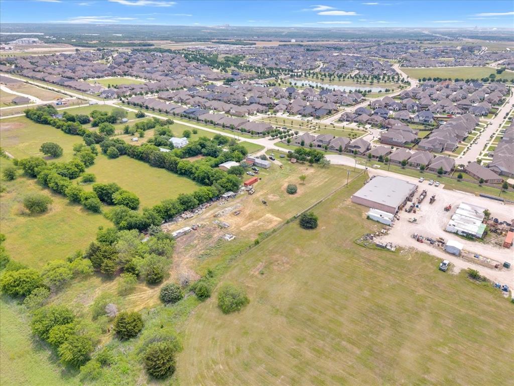 2511 Mathis Road Mansfield, TX 76063 - Photo 16 of 23 Land parcel featuring open fields, scattered mature trees, and a distant residential development