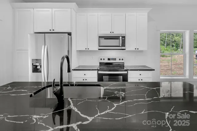 a kitchen with a sink and a hard wood floor