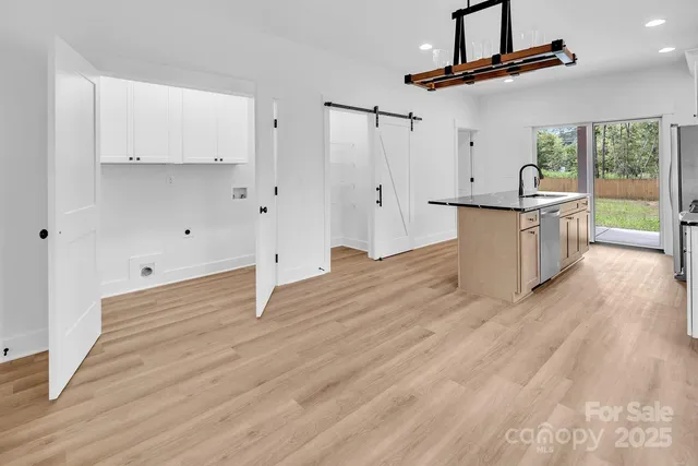 wooden floor in an empty room with a kitchen