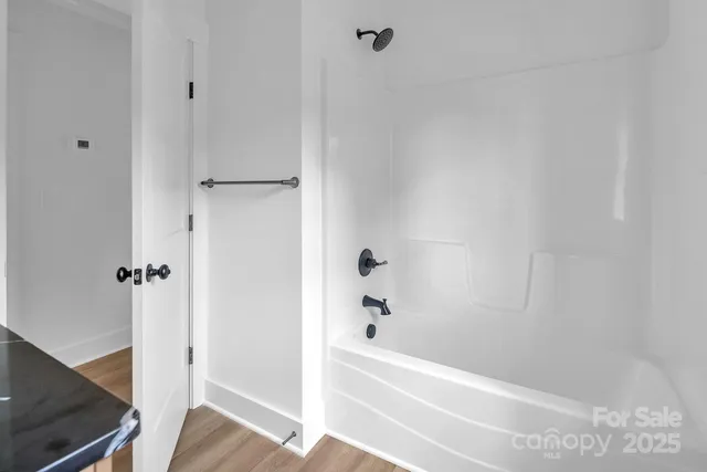 a spacious bedroom with a bed and a window