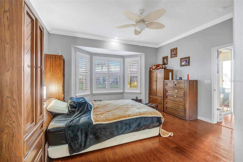 20804 Eustis Road Land O Lakes, FL 34637 - Photo 20 of 65 a bedroom with a bed dresser and a large window