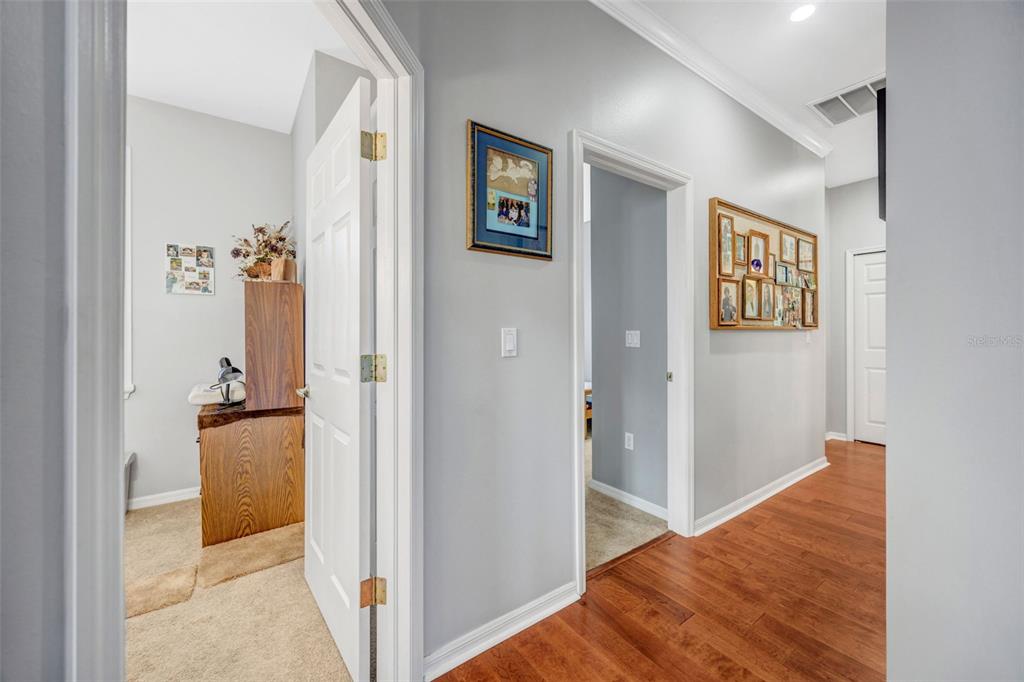 20804 Eustis Road Land O Lakes, FL 34637 - Photo 24 of 65 a view of a hallway with wooden floor and cabinet
