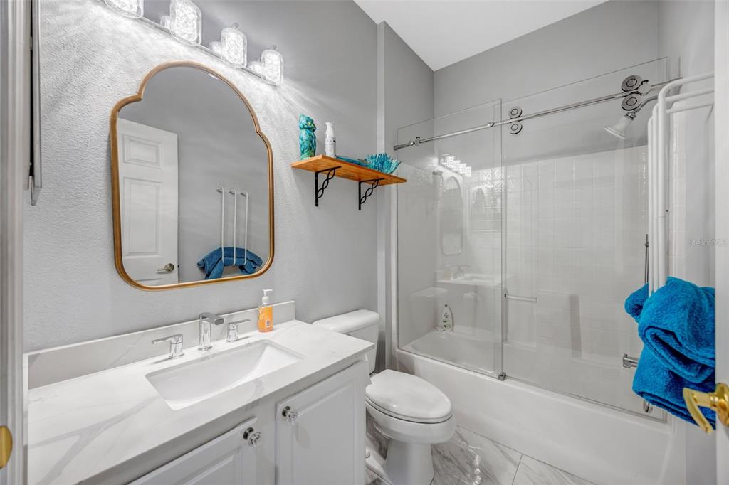 20804 Eustis Road Land O Lakes, FL 34637 - Photo 27 of 65 a bathroom with a sink toilet and shower