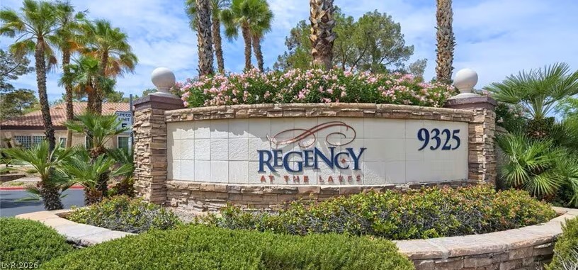 9325 West Desert Inn Road, Unit 278 Las Vegas, NV 89117 - Photo 13 of 17 A welcoming stone-clad entrance sign with lush landscaping and vibrant blooms.