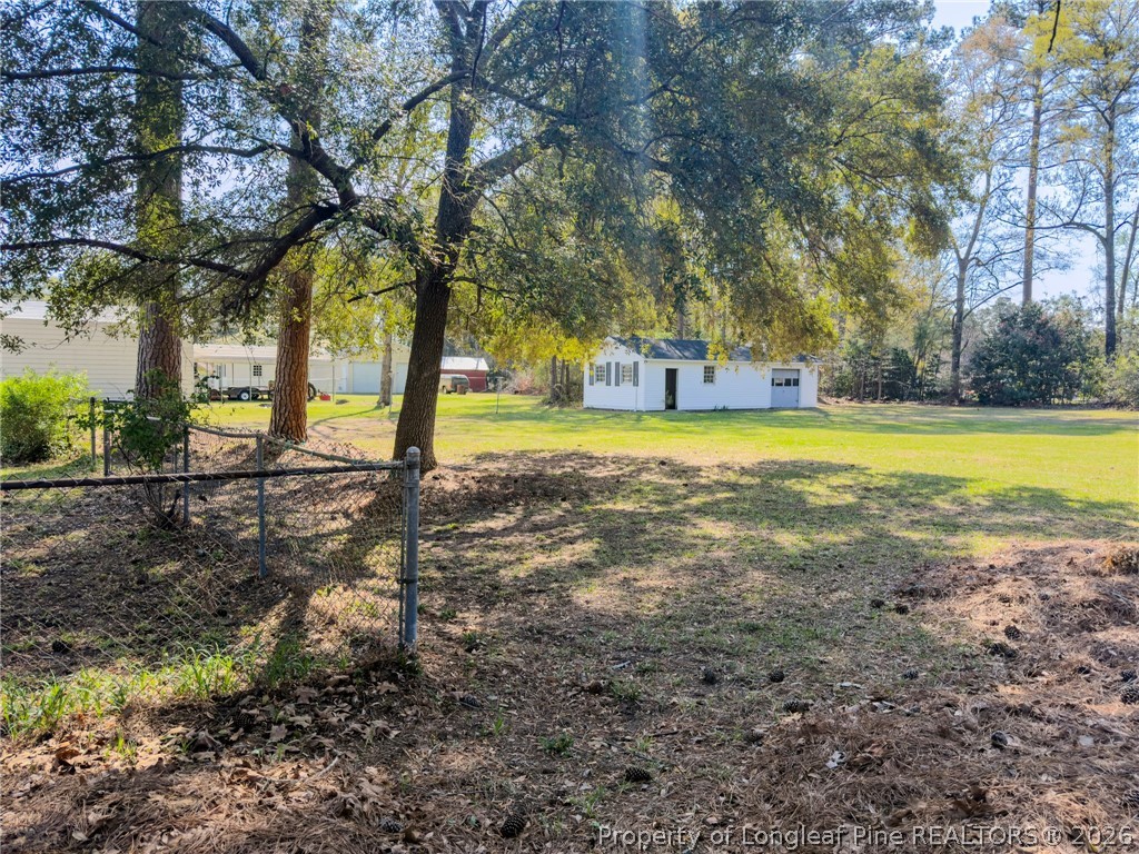598 Forest Road Lumberton, NC 28358 - Photo 22 of 25 a view of a yard with plants and large trees