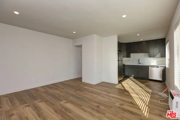 a view of a kitchen with wooden floor