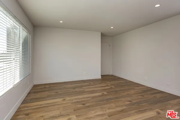 a view of room with wooden floor and window