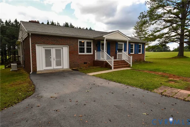 a front view of a house with garden and porch