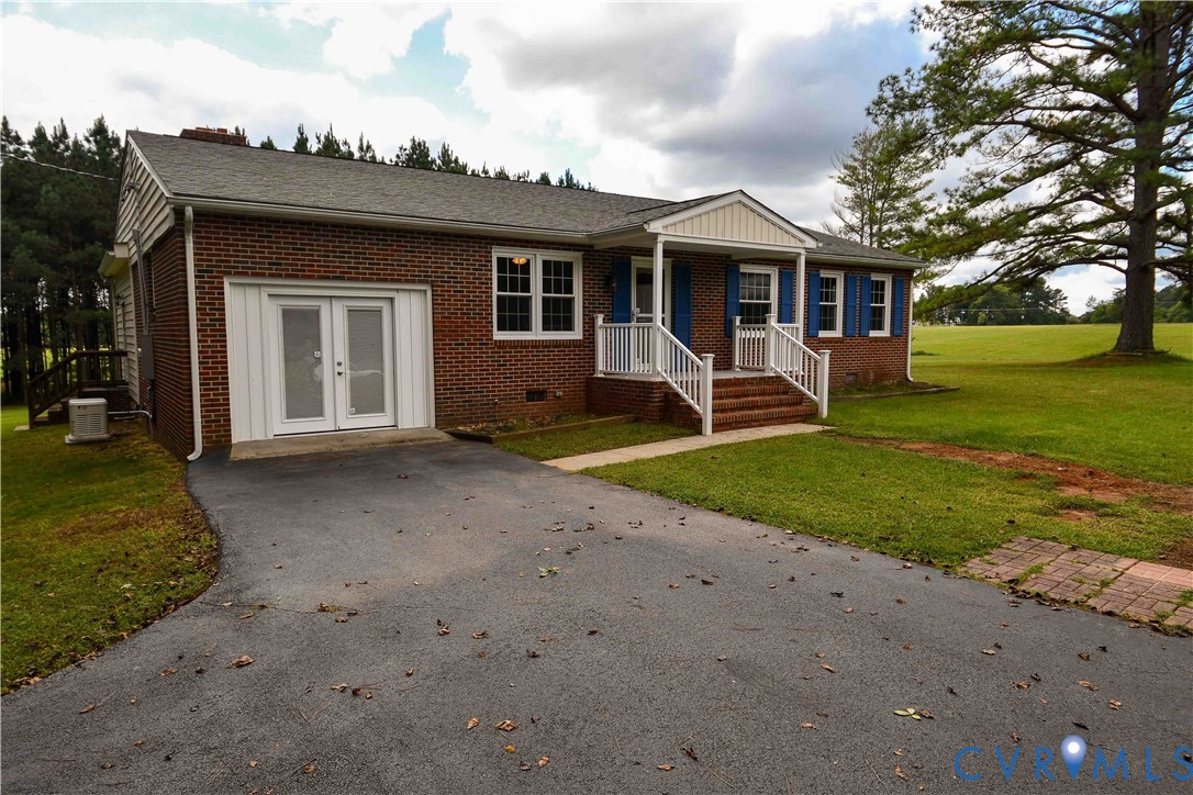 a front view of a house with garden and porch