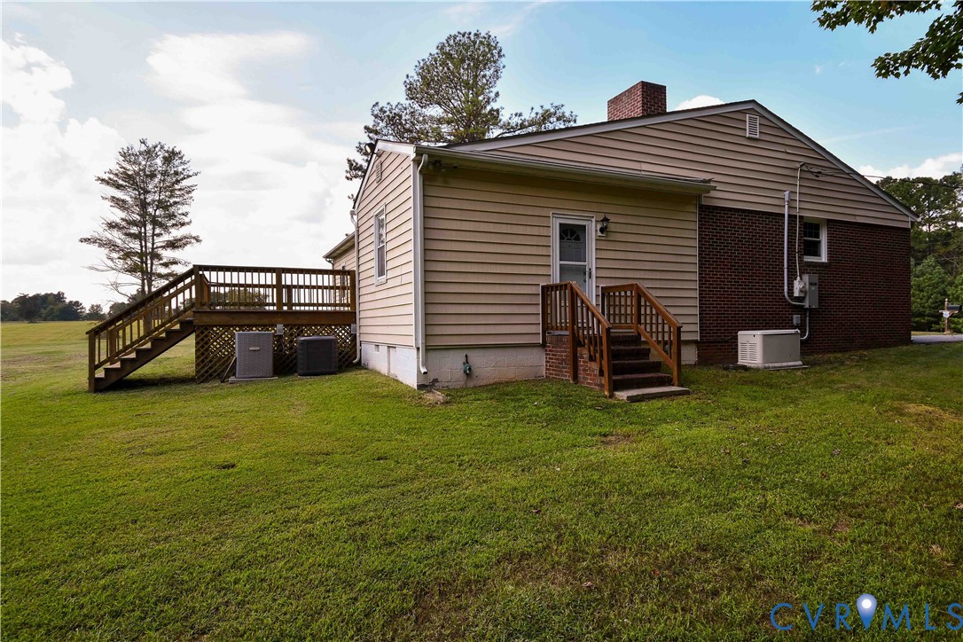 288 Daniel Road Blackstone, VA 23824 - Photo 11 of 38 Back of property with stairs, a yard, a chimney, a