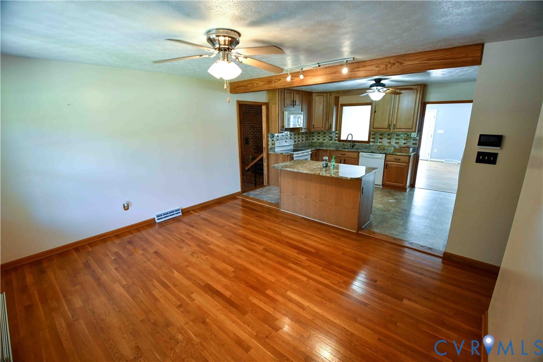 288 Daniel Road Blackstone, VA 23824 - Photo 12 of 38 Kitchen with brown cabinetry, rail lighting, a tex