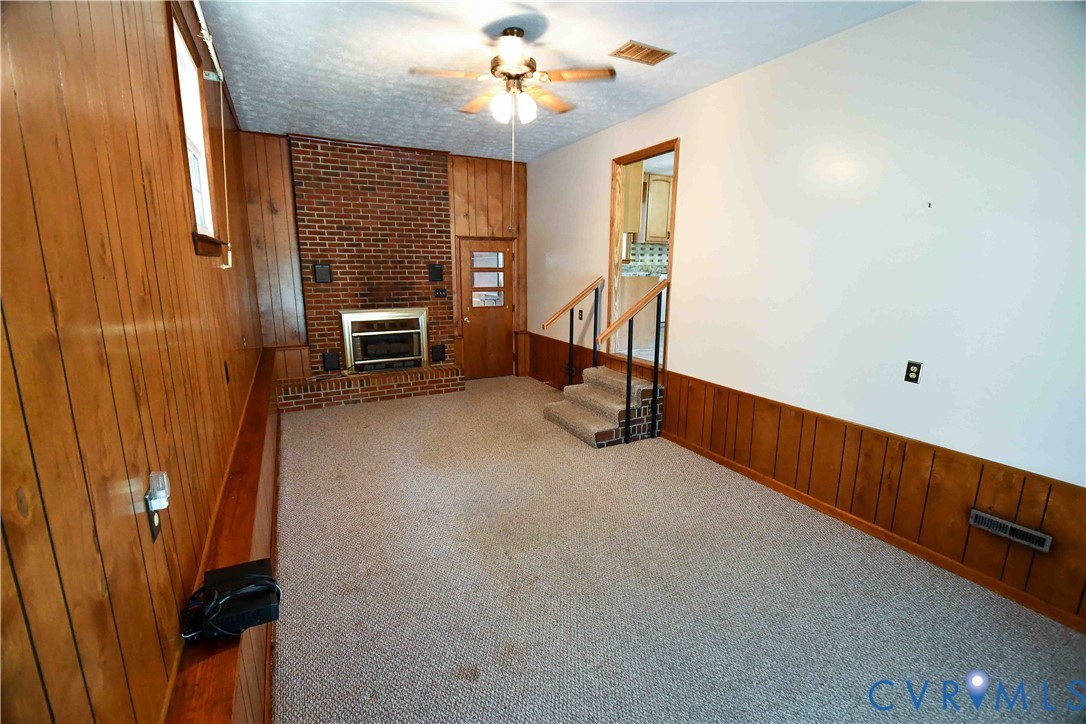 288 Daniel Road Blackstone, VA 23824 - Photo 14 of 38 Unfurnished living room with wood walls, a wainsco