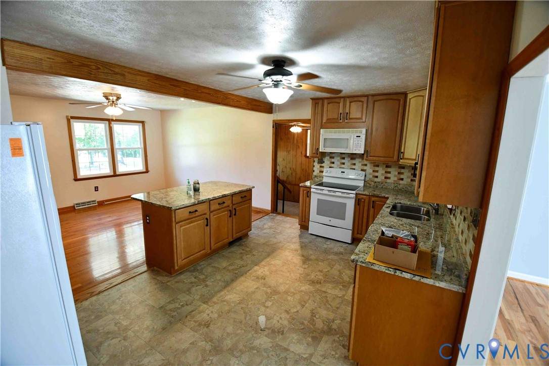 288 Daniel Road Blackstone, VA 23824 - Photo 17 of 38 Kitchen with white appliances, tasteful backsplash
