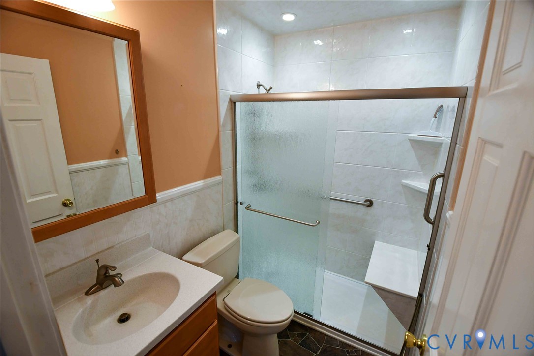 288 Daniel Road Blackstone, VA 23824 - Photo 24 of 38 Full bath with vanity, a shower stall, wainscoting