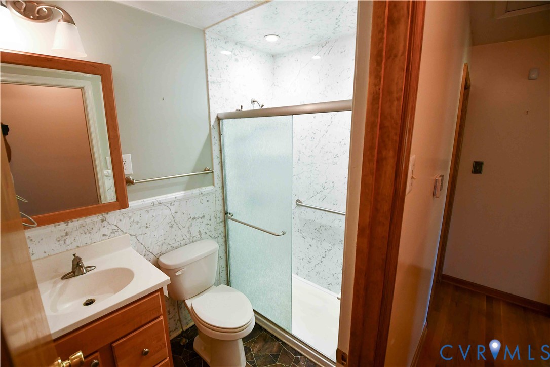 288 Daniel Road Blackstone, VA 23824 - Photo 26 of 38 Full bath with vanity, a shower stall, and tile wa