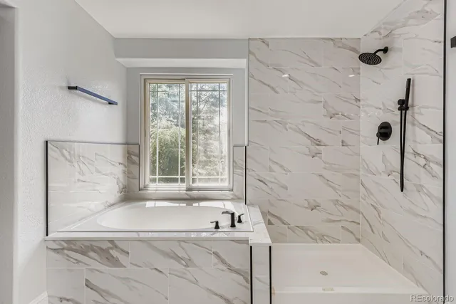 a bathroom with a bathtub and shower