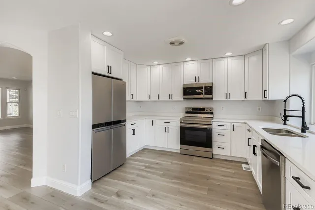 a kitchen with a refrigerator stove and microwave