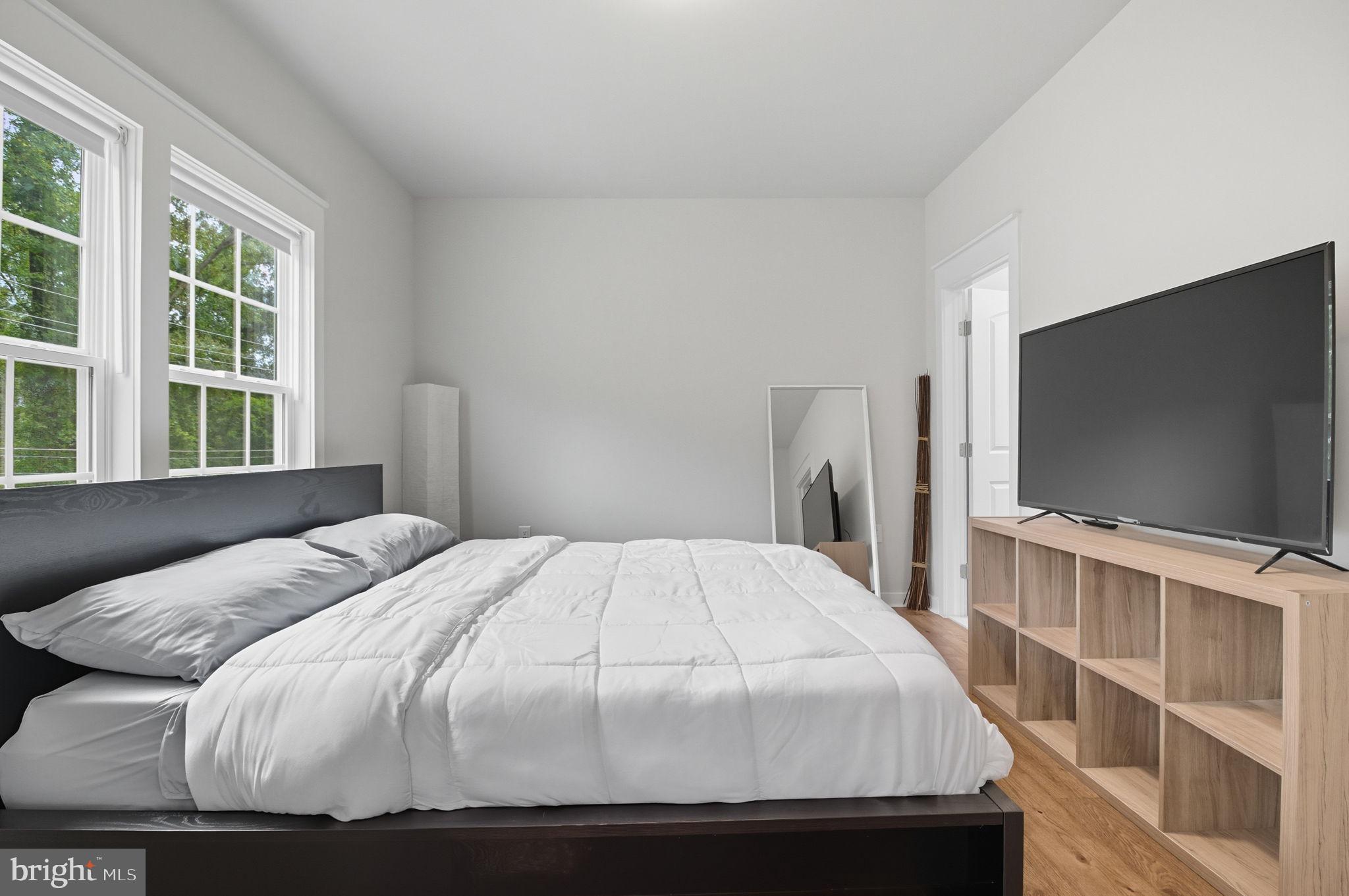 18518 Old Triangle Road Triangle, VA 22172 - Photo 16 of 39 a bedroom with a bed and a flat screen tv