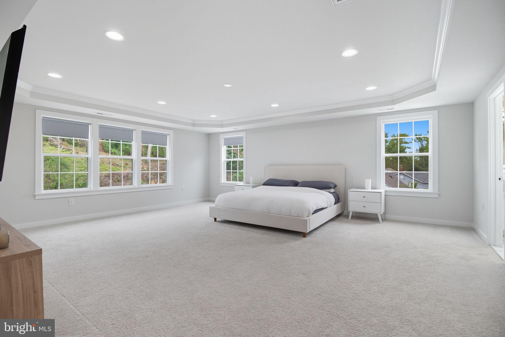 18518 Old Triangle Road Triangle, VA 22172 - Photo 17 of 39 a spacious bedroom with a large bed and a large window