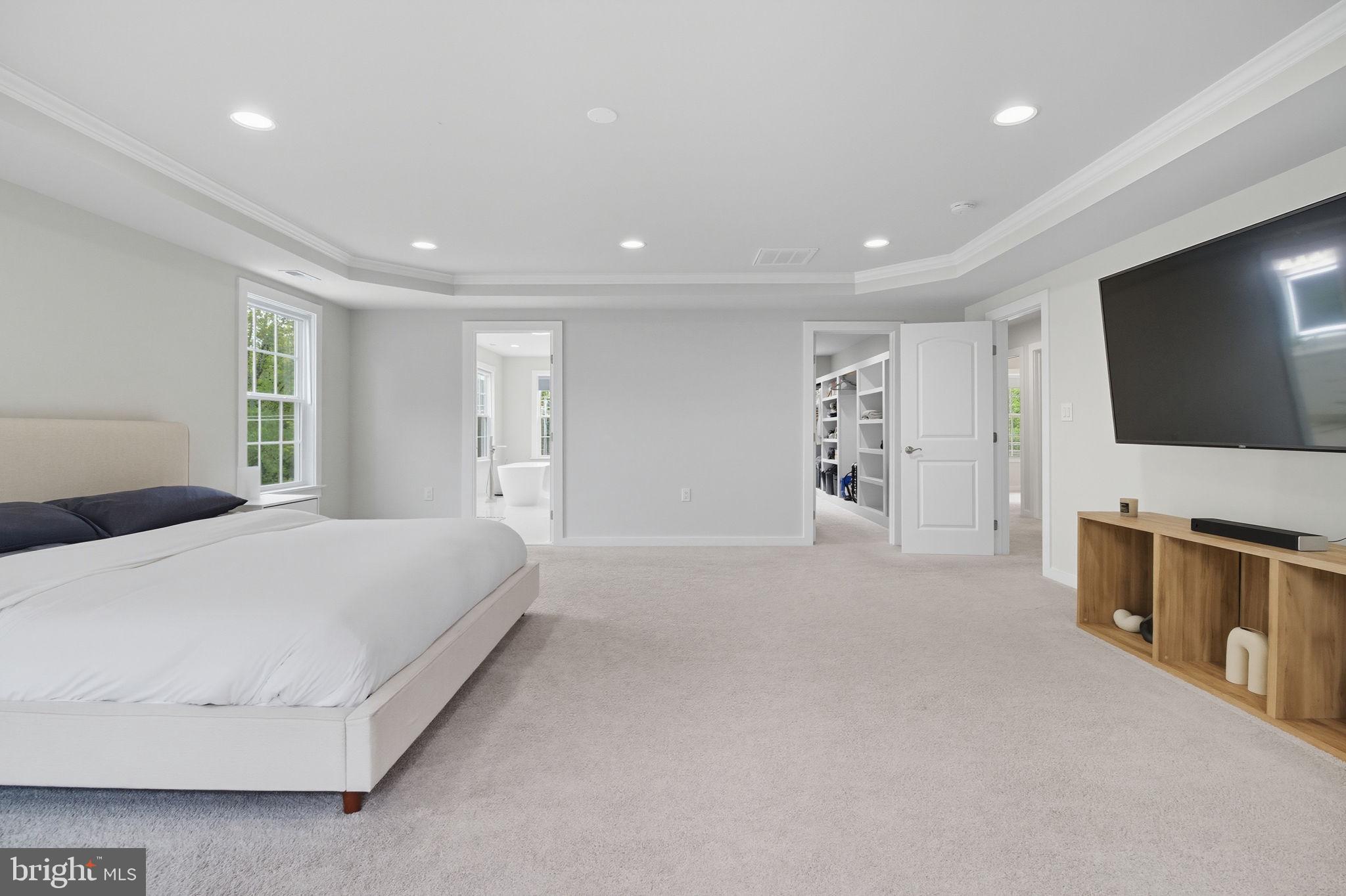 18518 Old Triangle Road Triangle, VA 22172 - Photo 18 of 39 a spacious bedroom with a bed and a flat screen tv