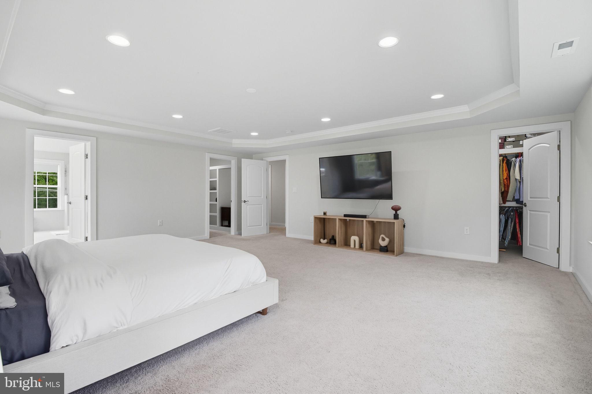 18518 Old Triangle Road Triangle, VA 22172 - Photo 19 of 39 a spacious bedroom with a bed and a flat screen tv
