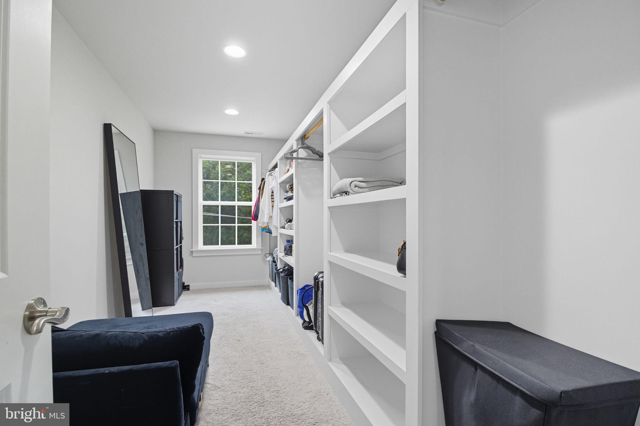 18518 Old Triangle Road Triangle, VA 22172 - Photo 21 of 39 a view of walk in closet with clothes and shoes