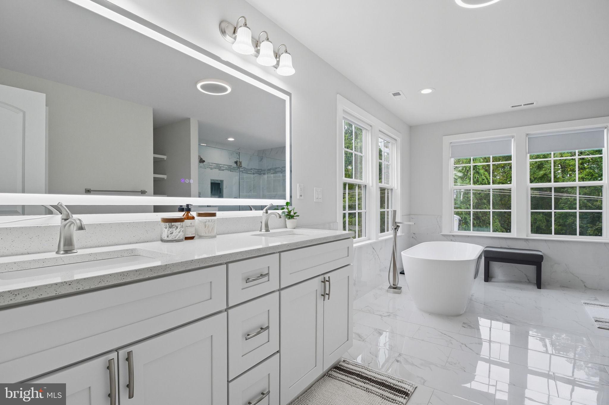 18518 Old Triangle Road Triangle, VA 22172 - Photo 22 of 39 a spacious bathroom with a double vanity sink large mirror and a bathtub