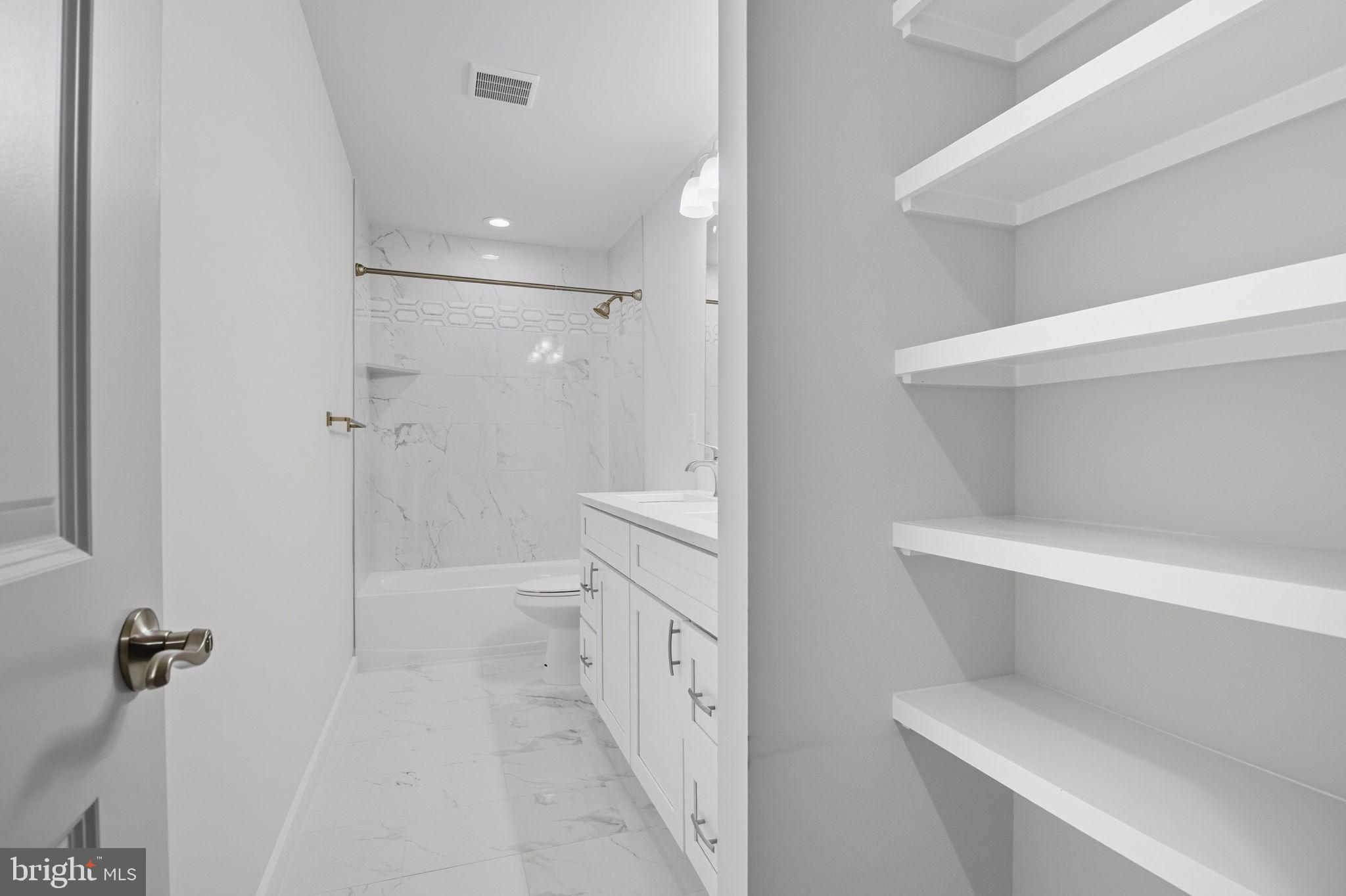 18518 Old Triangle Road Triangle, VA 22172 - Photo 30 of 39 a bathroom with a toilet sink and shower