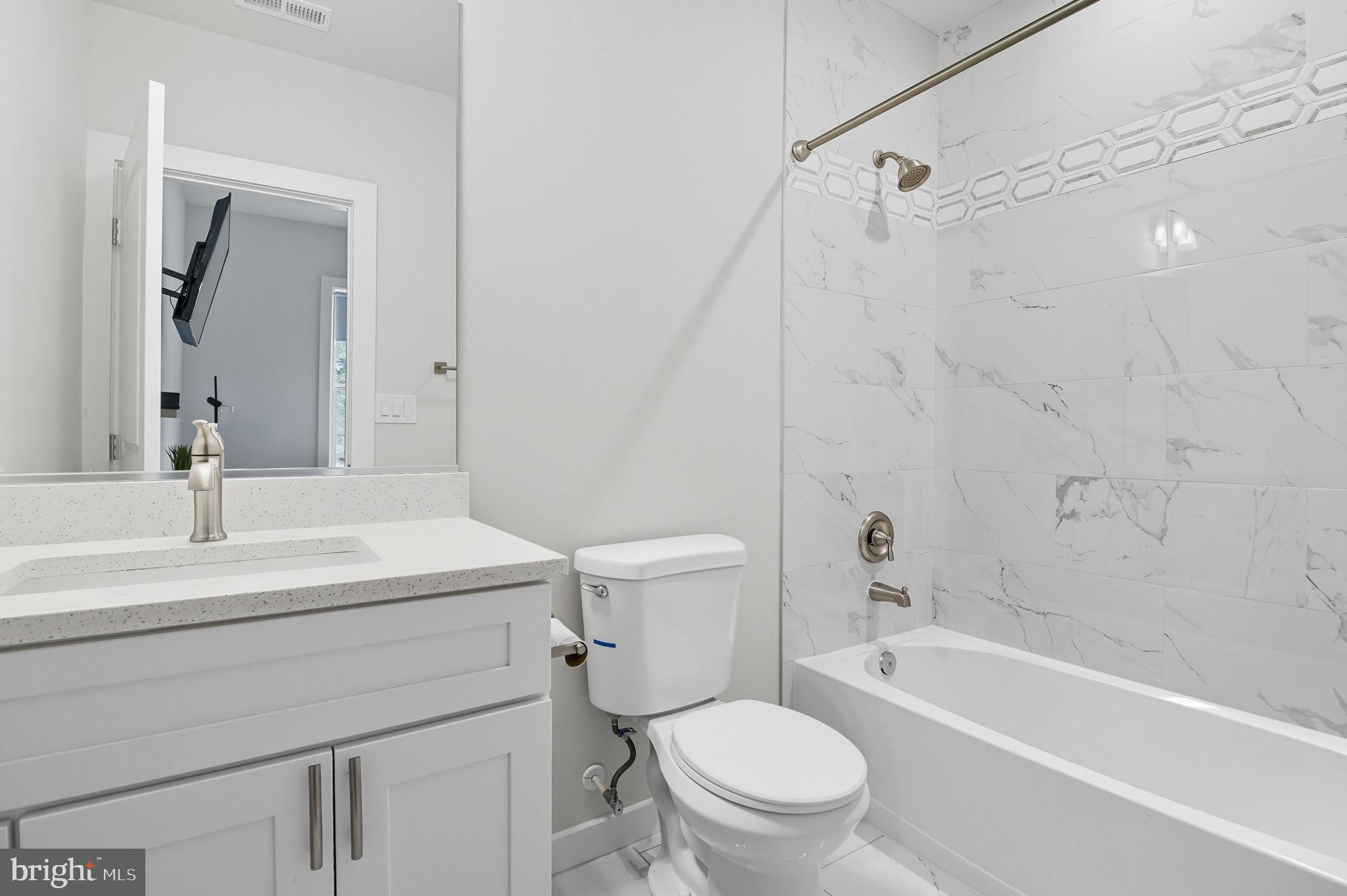 18518 Old Triangle Road Triangle, VA 22172 - Photo 32 of 39 a bathroom with a sink a toilet and a bathtub