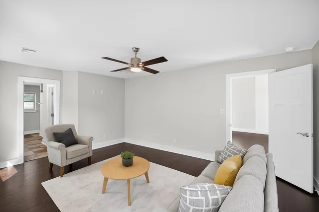 a living room with furniture and a potted plant