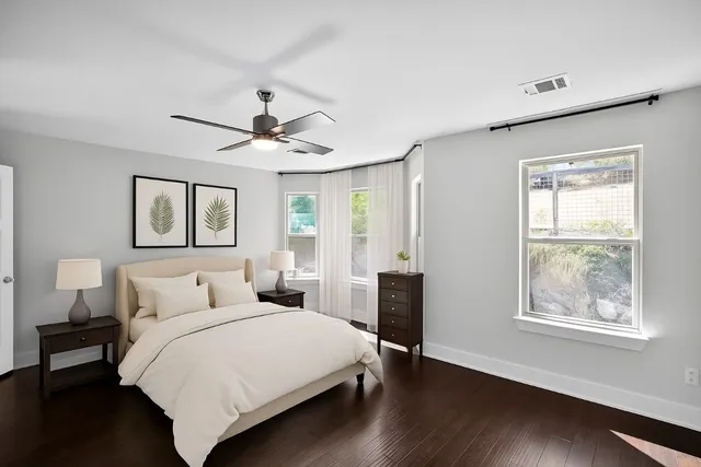 a bedroom with a large bed and a window