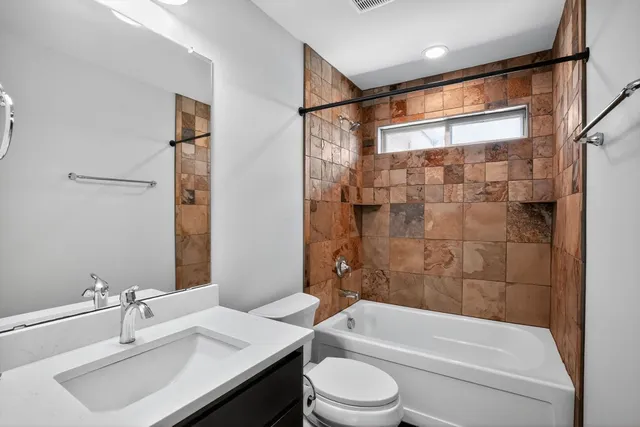 a bathroom with a sink mirror toilet and bathtub